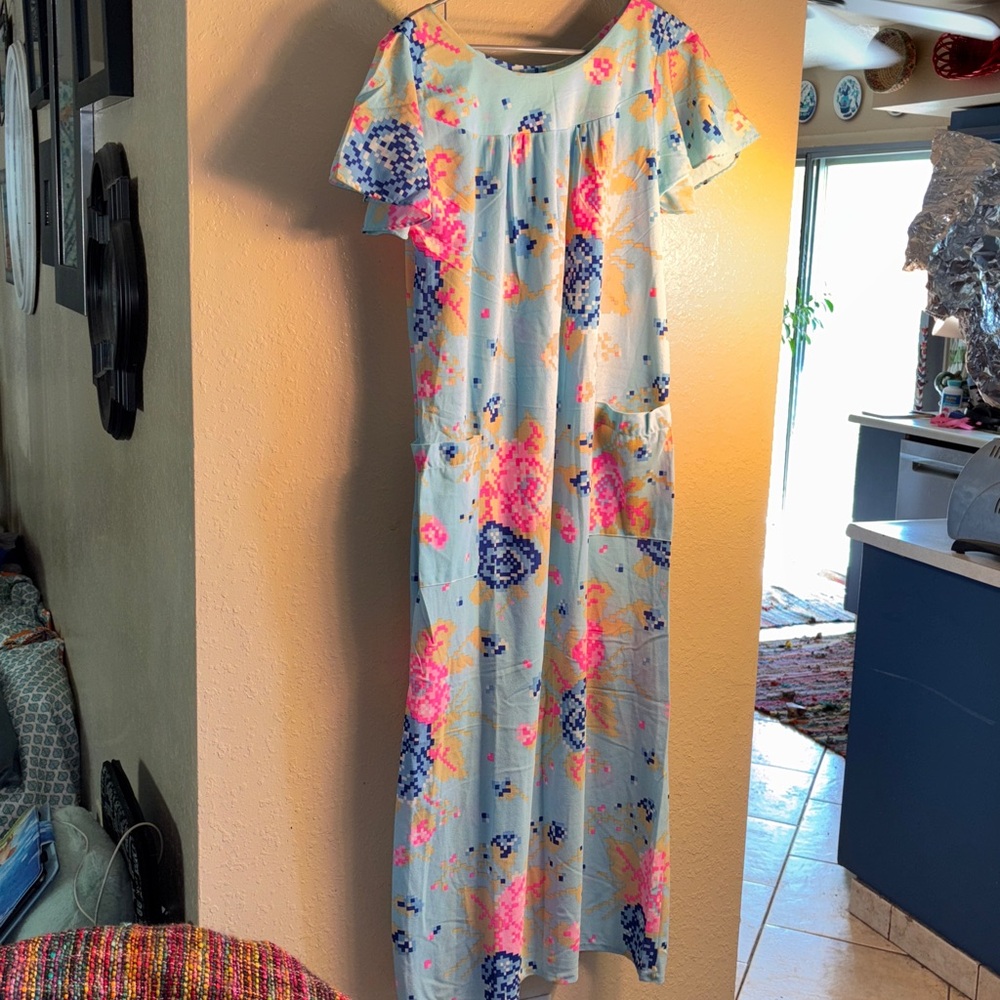 Vintage Muumuu Light blue background with blue and neon, pink, pixelated flowers